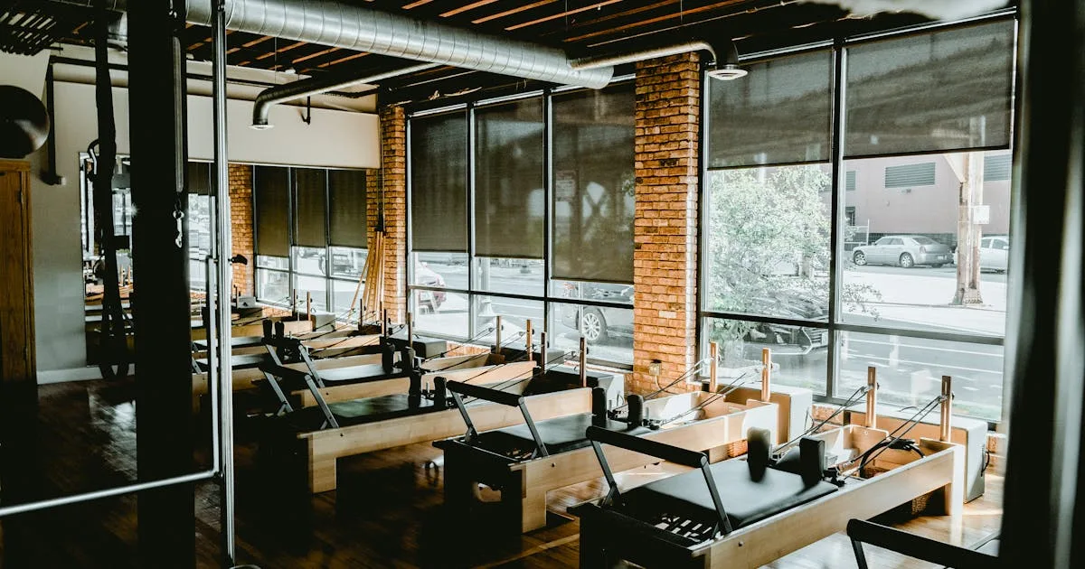 Three ladies are doing yoga on mats in a gym center