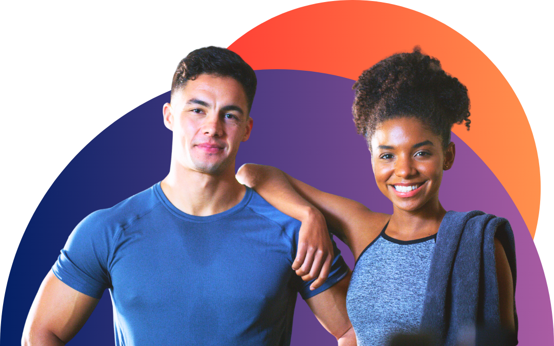 A personal trainer and a gym member smiling together