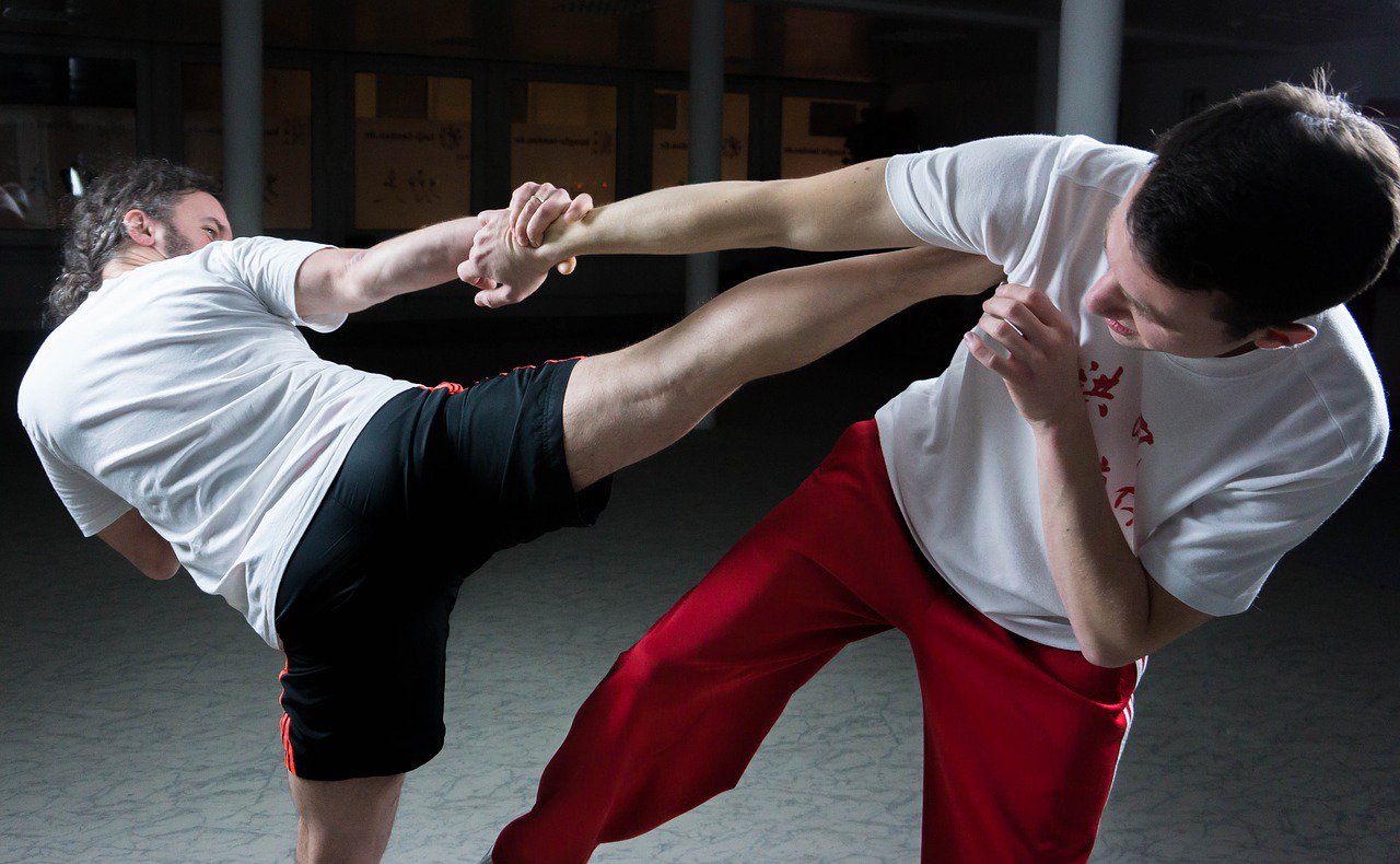 Two young men sparring, practicing kung fu martial arts