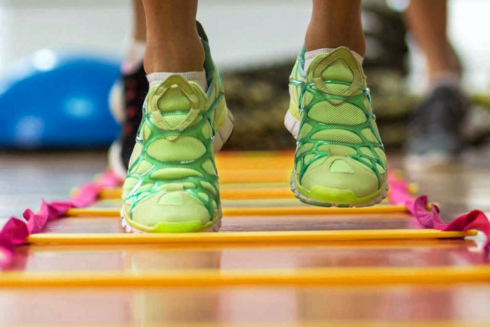 Closeup of feet, ladder speed exercise during sports training session