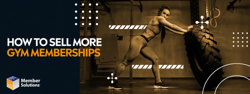 A woman in workout gear pushes a large tire in a gym